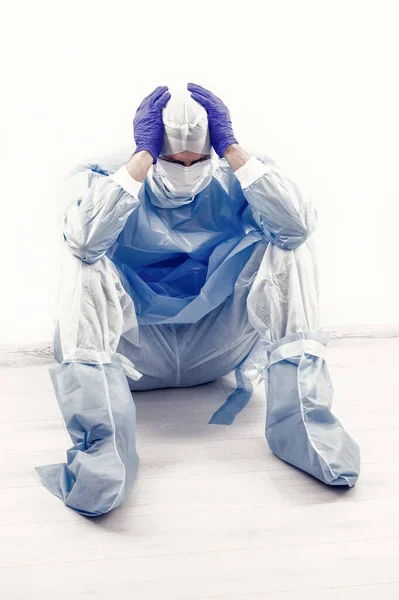 stock image man has headache wear safety costume. doctor in respirator medical mask. hygiene on coronavirus pandemic. scientist create virus vaccine. epidemic outbreak quarantine. covid-19 and healthcare.