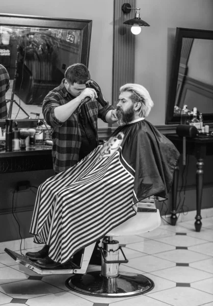 hair cut and beard care for caucasian guy in barbershop, occupation.