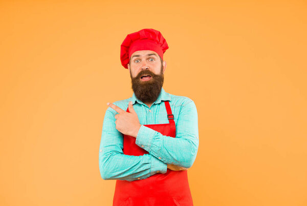 Food is our forte. Male chef in red uniform. mature hipster pointing finger. satisfied bearded chef. brutal butcher in apron. best menu offer. confident bearded happy chef white uniform.