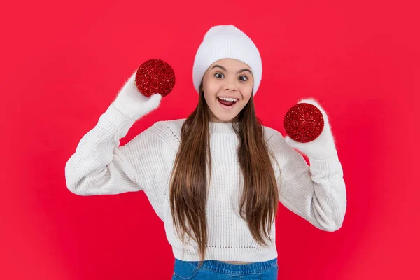 merry christmas. surprised teen girl with red christmas decoration in studio. teen christmas girl isolated on red background.