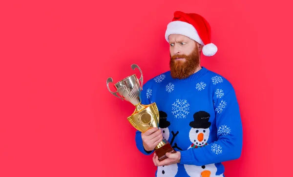 christmas achievement. shocked man winner with christmas achievement. winner man has achievement in christmas isolated on studio red background.