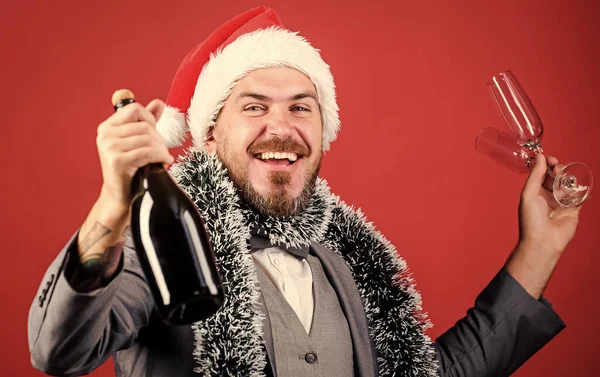 happy time. winter holidays. happy man celebrating xmas. corporate new year party. businessman in santa hat with tinsel. christmas time for fun. man business suit drink champagne from glasses. cheers.