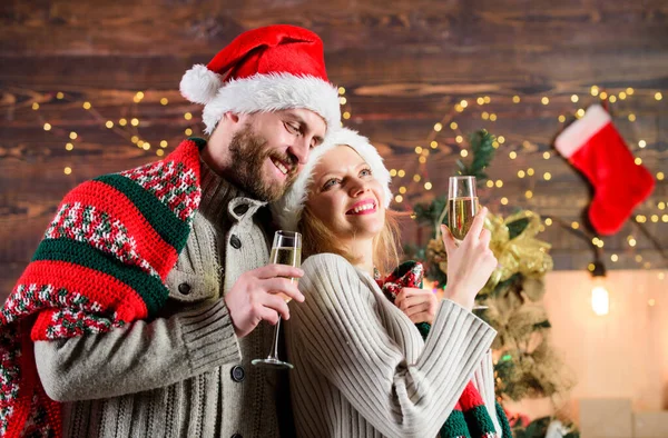 Make christmas wish. Couple in love cuddling enjoy christmas holiday celebration. Drinks for adults. Happy new year. Merry christmas. Celebrating christmas together. Home party. Festive atmosphere.