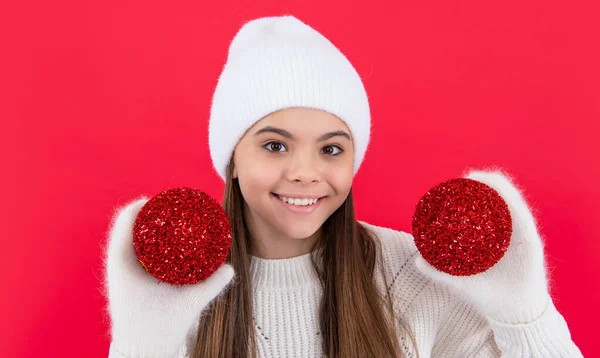 merry christmas. positive teen girl with red christmas decoration in studio. teen christmas girl isolated on red background.