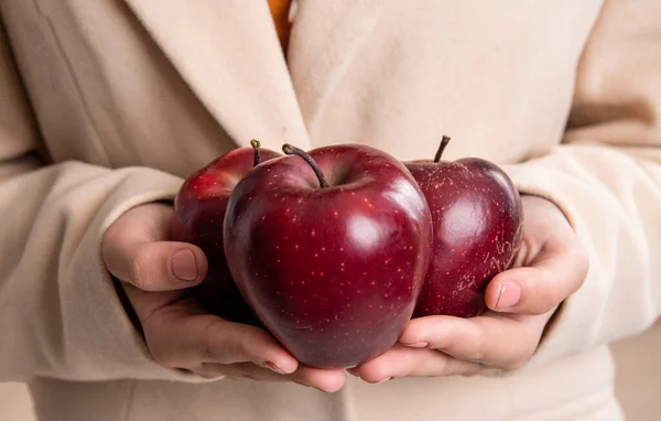 red apple in hands. hold apple in closeup. healthy apple fruits. photo of apple.