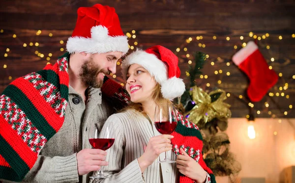 Romantic evening. Christmas ideas for couples. Romantic date with red wine. Man and woman in love cuddling enjoy intimacy festive atmosphere. Romantic couple. Family celebrate winter holiday at home.
