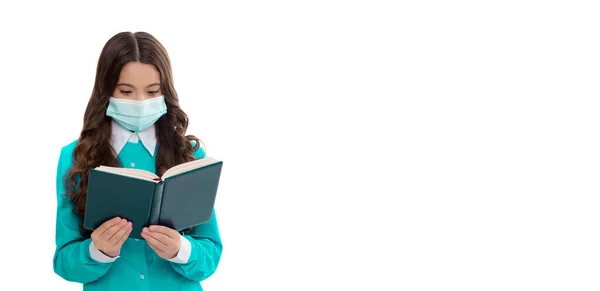 school girl in medical mask with copy space. school girl in mask read book on quarantine isolated on white. school girl in mask read book. social distancing. photo of girl in quarantine mask.
