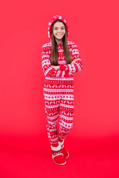 happy new year. positive teen girl in red new year clothes standing in studio. teen new year girl isolated on red background.