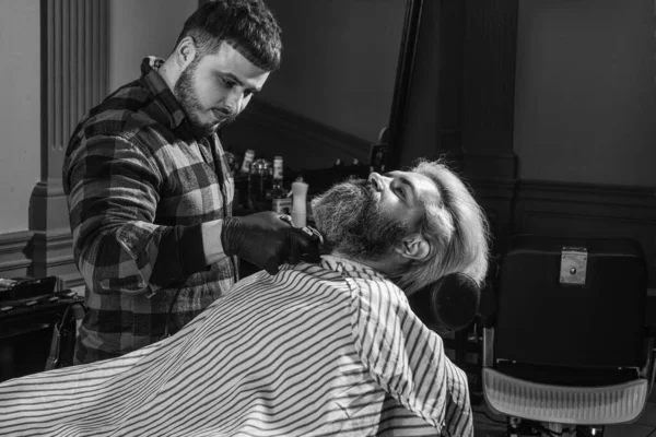 Barber is essential resource for your style. Shaving with razor. Facial hair. Maintaining beard shape. Grow beard and mustache. Man at barbershop. Hairdresser salon. Professional barber and client.