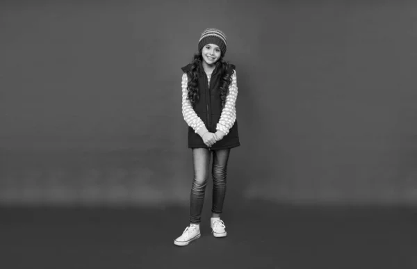 Kış Şapkalı Kırmızı Arka Planda Yelekli Gülen Bir Çocuk Soğuk — Stok fotoğraf
