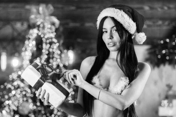 Sexual wish. Private party. Girl christmas tree. Christmas role games. Promoting goods for adults. I will fulfill your wishes. Woman red lingerie. Female underwear. Sexy Santa Claus in fancy bra.