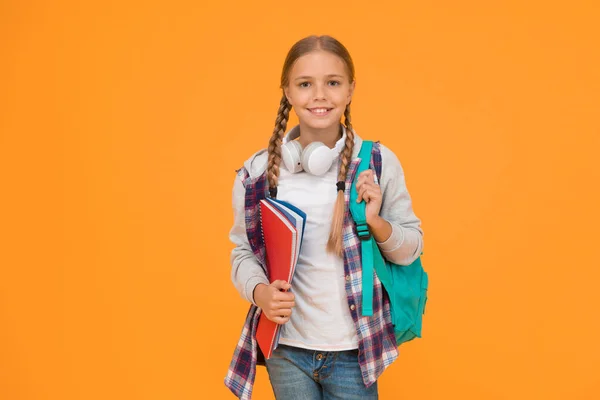 Motivated and diligent. Stylish schoolgirl. Girl little fashionable schoolgirl carry backpack. Schoolgirl daily life. School club. Modern education. Private schooling. Teen with backpack and books.