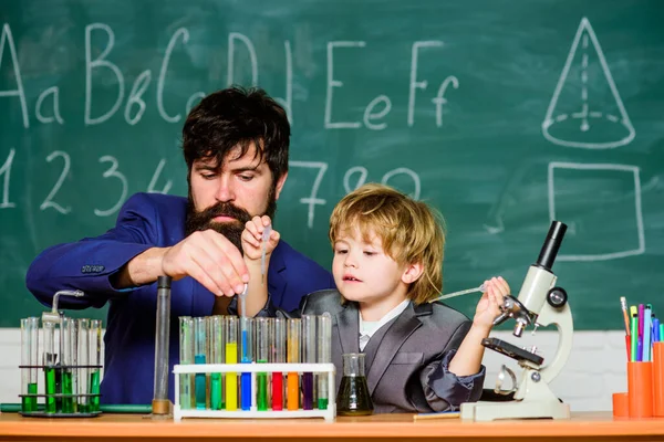 Chemistry and physics biology. bearded man teacher with little boy. father and son at school. Back to school. Explaining biology to child. biotechnoloy research concept. Changes for the Better.