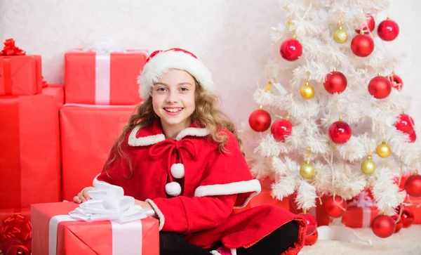 Winter shopping sales. Christmas spirit is here. Winter holiday tradition. Kid happy with christmas present. Girl celebrate christmas open gift box. Unpacking christmas gift. Santa bring her gift.
