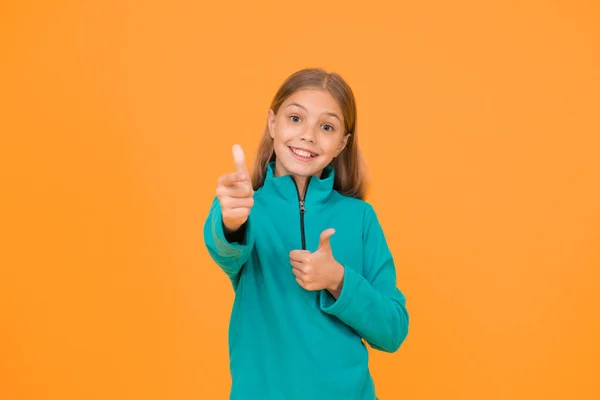Good choice. Happy girl pointing gun hand gesture. Target and targeting. Small child smiling and pointing yellow background. Pointing gesture as nonverbal communication. Pointing and aiming.