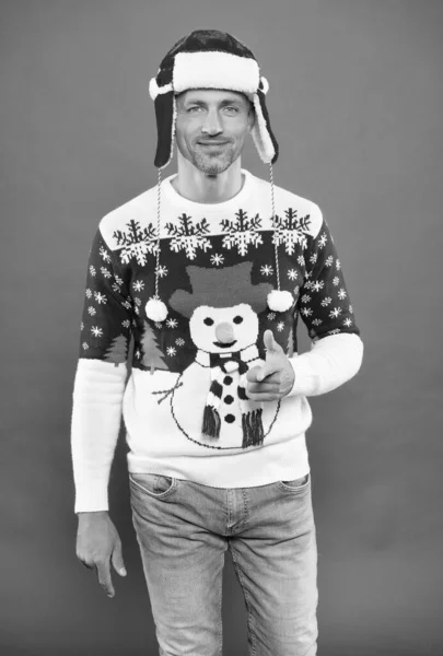 man in sweater and hat wish happy new year and merry christmas holiday ready to celebrate party with fun and joy full of xmas presents, male winter fashion.