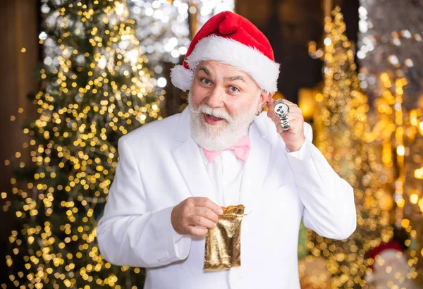 Look at that. elite and expensive gift. new year gift for men. luxury and people concept. happy man with watch illuminated background. santa businessman has wristwatch present.
