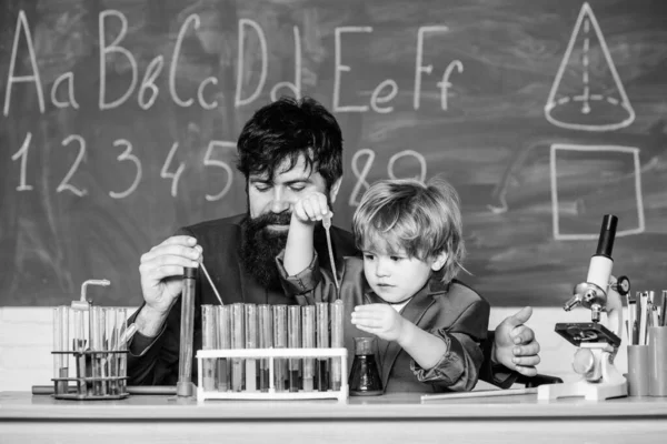 Know How. laboratory research and development. teacher man with little boy. School education. father and son at school. Back to school. science camp. Chemistry beaker experiment.