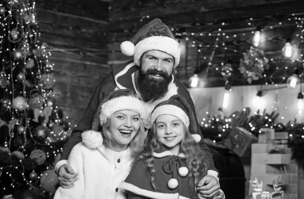 Bright memories. lot of xmas present boxes. Portrait loving family. merry christmas. Father and mother love daughter. Happy family celebrate new year. small child and parents in santa hat.