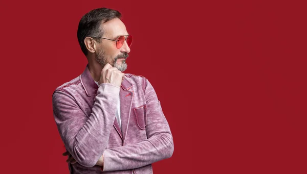mature man wear stylish jacket, copy space. photo of mature stylish man. mature stylish man in glasses isolated on red background. mature stylish man in studio.