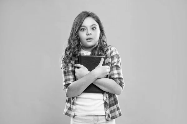 shocked pupil or student hold notebook. teen girl study with book. child holding copybooks. concept of knowledge and wisdom. back to school. childhood education.