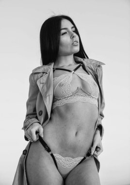 Hot body. Shameless concept. Beautiful lingerie. Tender lace covering her nipples. Girl long hair posing sexy erotic style. Woman sexy taking off coat sunset sky background. Sexy lady concept.