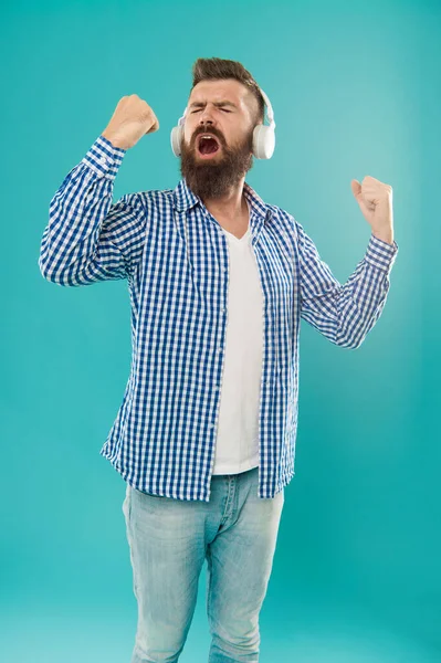 classical music lover. guy with beard and moustache wear headphones. male express emotions. elearning with audio book. brutal bearded hipster in checkered shirt. singing mature man listen music.