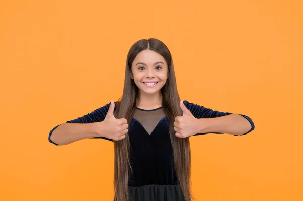 Satisfaction guaranteed. Happy child show thumbs ups yellow background. Satisfactory hand gesture. Satisfaction concept. Fashion and style. Hair salon. Beauty and look.