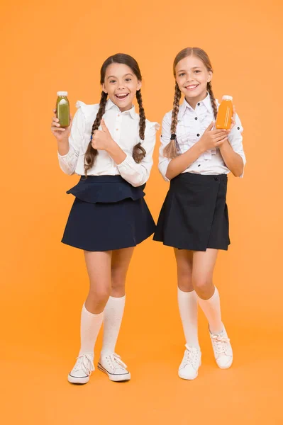 Nutrição Saudável Estudantes Segurando Garrafa Suco Fundo Amarelo Saciar Sede — Fotografia de Stock
