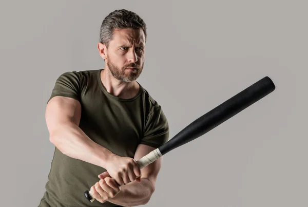 aggression of angry criminal man with bat in studio. photo of angry man hold bat. angry man threatening. angry man express anger with bat isolated on grey background.