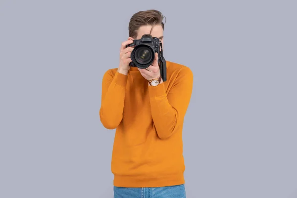 man photographer with camera isolated on grey background. man photographer with camera in studio. man photographer with photo camera. photo of man photographer with camera.