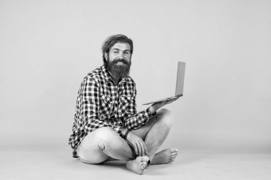 Kafkasyalı yetişkin hippi iş adamı, modaya uygun saç stili, kareli gömlekli bilgisayar, çevik iş adamı..