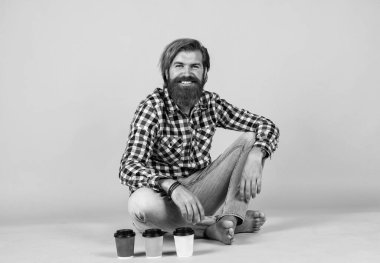 Hoş gülümseme. Kahveli yakışıklı hippi adam. Kahve molası veriyor. Fincandan su içen yakışıklı bir yetişkin. Bir fincan kahve ya da çay al. yaşam tarzı konsepti.