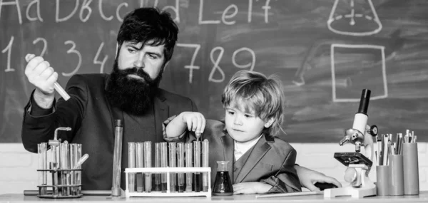 Genius minds. Special and unique. Genius child private lesson. Knowledge day. Genius kid. Joys and challenges raising gifted child. Teacher bearded scientist man child test tubes. Chemical experiment.