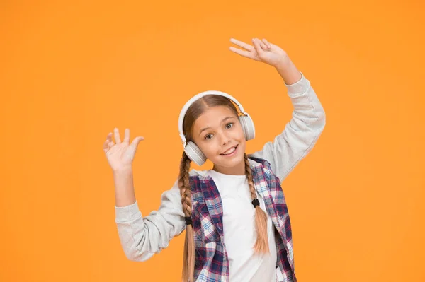 Wireless means freedom. Headphones with wireless technology. Small child listening to music modern wireless earphones. Happy little girl wearing modern headphones. Cute kid enjoying stereo sound.