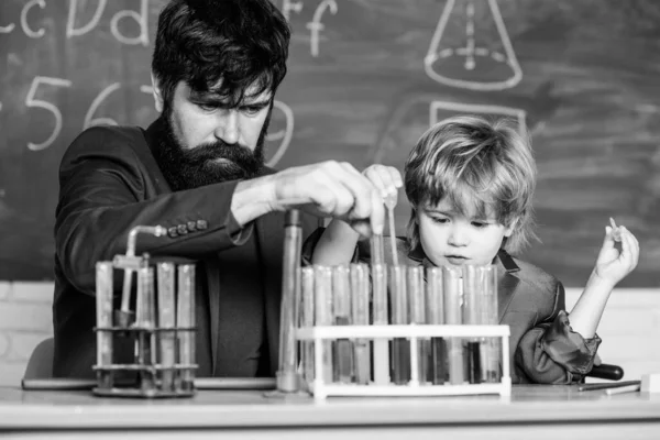 Experience and innovation in a single touch. biology and chemistry education. Back to school. Educational concept. teacher man with little boy. School education. father and son at school.