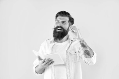 laughing bearded man with book on yellow background, emotions.