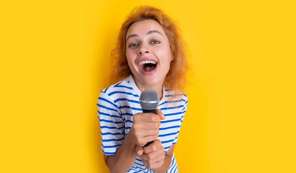 stock image glad karaoke woman singer isolated on yellow background. young singer woman sing in karaoke studio. woman karaoke singer with microphone.