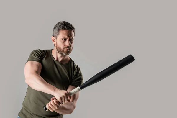 photo of angry man hold bat. angry man threatening with baseball bat. angry man express anger with bat isolated on grey background. aggression of angry man with bat in studio.