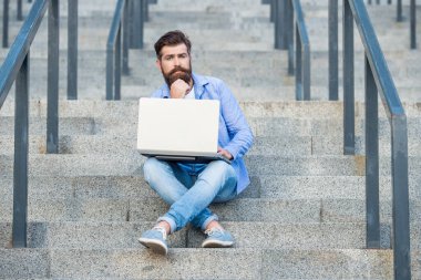 Düşünceli serbest çalışan adamın dışarıda online bilgisayarı var. Serbest çalışan bir adamın sokakta bilgisayar bağlantısı var. Dizüstü bilgisayarı olan serbest çalışan bir adam. Serbest çalışan adamın çevrimiçi bilgisayarı var.