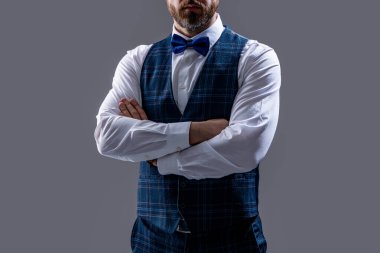 cropped view of confident tuxedo man in formalwear with bowtie. tuxedo man in formalwear isolated on grey background. tuxedo man in formalwear at studio. tuxedo man wear formalwear fashion.