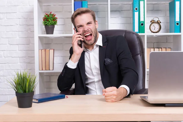 angry businessman has phone talk in studio. businessman has phone talk on background. photo of businessman has phone talk. businessman has phone talk isolated on white.