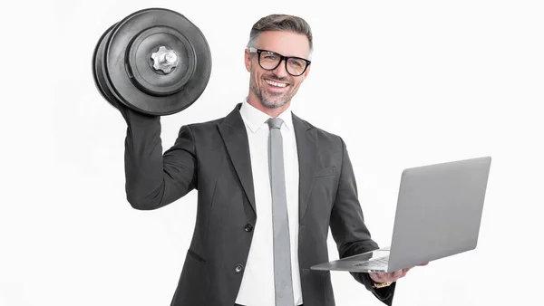 stock image smiling businessman in suit hold heavy dumbbell and laptop isolated on white background.