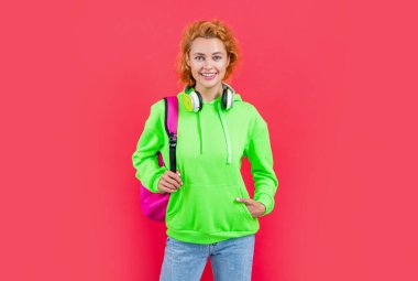 happy school woman student at studio. photo of school woman student hold backpack. school education of woman student. school woman student isolated on red background.