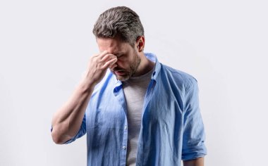 man with headache or migraine isolated on grey. mature man with headache and migraine in studio. photo of man with migraine headache. man with headache or migraine wear shirt.
