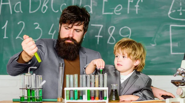 Genius minds. Genius kid. Joys and challenges raising gifted child. Teacher bearded scientist man child test tubes. Chemical experiment. Special and unique. Genius child private lesson. Knowledge day.