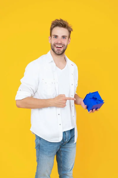 smiling man with present in studio. man with present on background. photo of man with present box. man with present isolated on white.