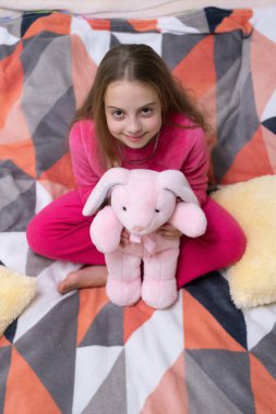 childhood of teen girl relax wearing pajama holding toy. childhood of teen girl relax. childhood of teen girl relax in bed. childhood of teen girl relax in bedroom.