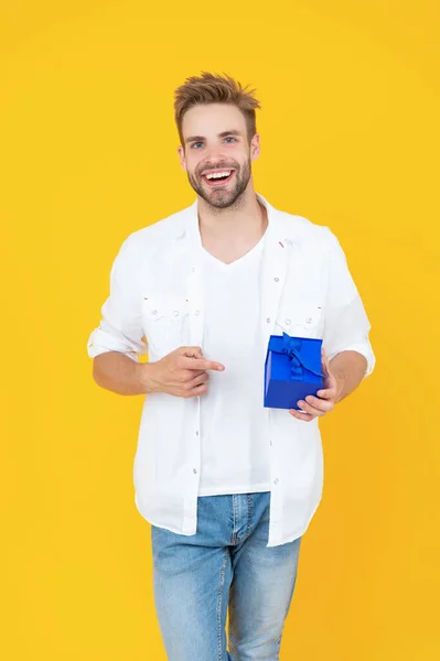 cheerful man with present isolated on white. man with present in studio. man with present on background. photo of man with present box.