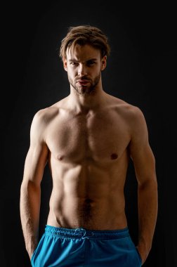 muscular athletic man with abs isolated on black background. man with muscular abs in studio. muscular man with abs muscles. photo of man with muscular abs.